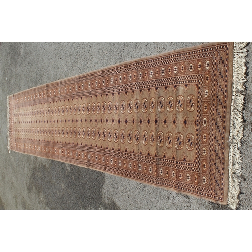 2 - Pakistan Turkoman design runner with two lines of gols and multiple borders on a beige ground, 400cm... 