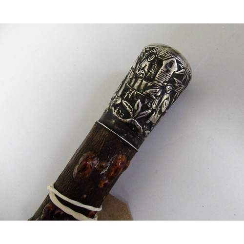 216 - Chinese white metal mounted walking cane, the handle decorated with various figures in a setting wit... 