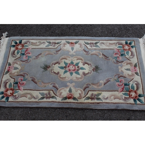 24 - Chinese rug with medallion and floral design on a pink ground, 183cms x 122cms together with a simil... 