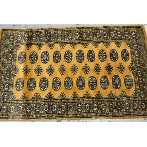 27 - Pakistan rug of Turkoman design with two rows of gols on a beige ground, 153cms x 90cms