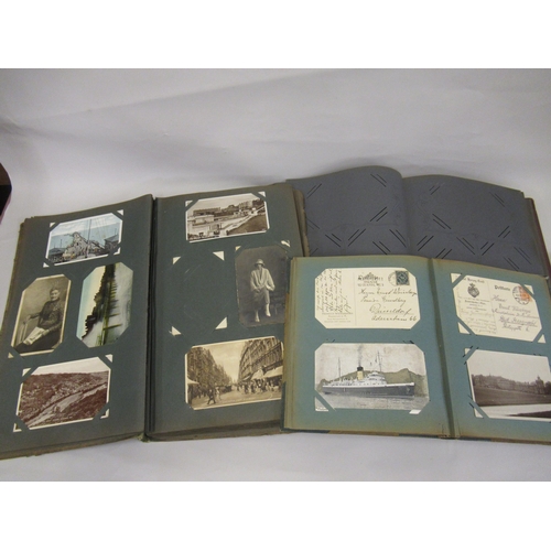 274 - Two albums containing various early 20th Century postcards and photographs, together with an empty a... 