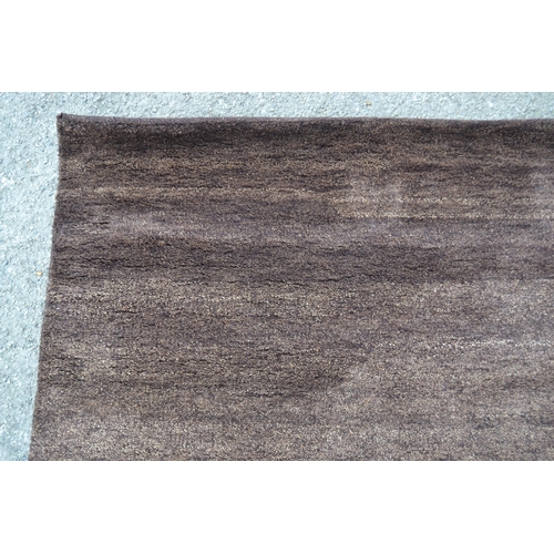 28 - Modern Indian Gabbeh design rug in plain mottled dark tan, 150cms x 240cms