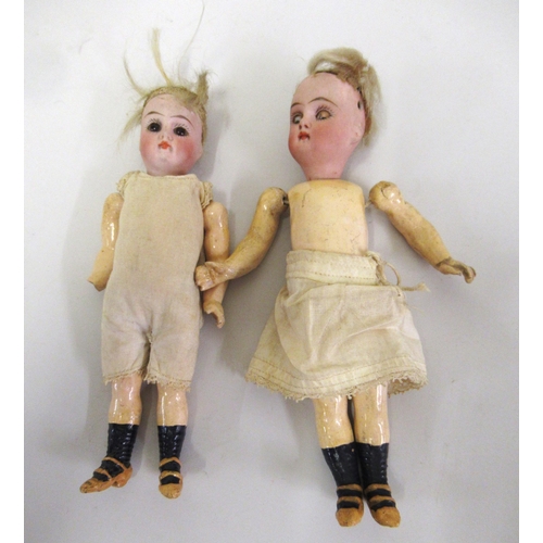 302 - Two 19th Century miniature bisque headed dolls, with articulated papier mache bodies (one with sleep... 