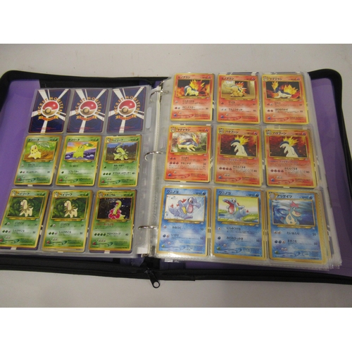 355 - Folder containing a large quantity of Japanese and American Pokemon cards including Base, Jungle, Fo... 