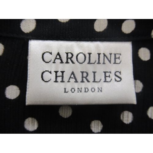37 - Caroline Charles, London, black and white polka dot blouse and matching skirt, with original packagi... 