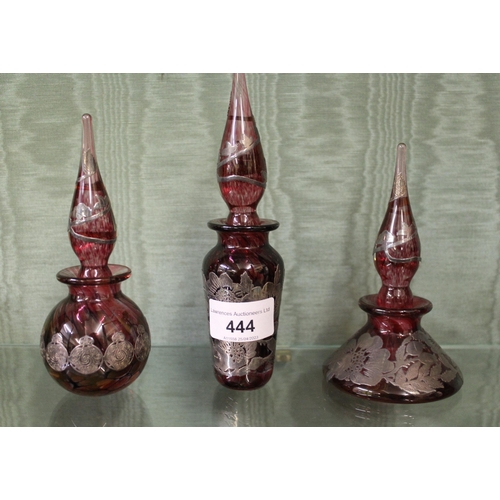 444 - Three ruby glass perfume bottles by Laugharne