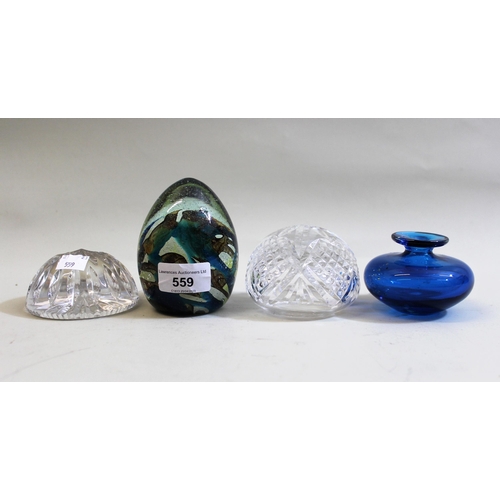 559 - Three various 20th Century glass paperweights and a vase by Mdina