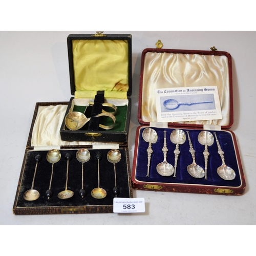 583 - Two cased sets of silver coffee spoons, together with a silver spoon and pusher