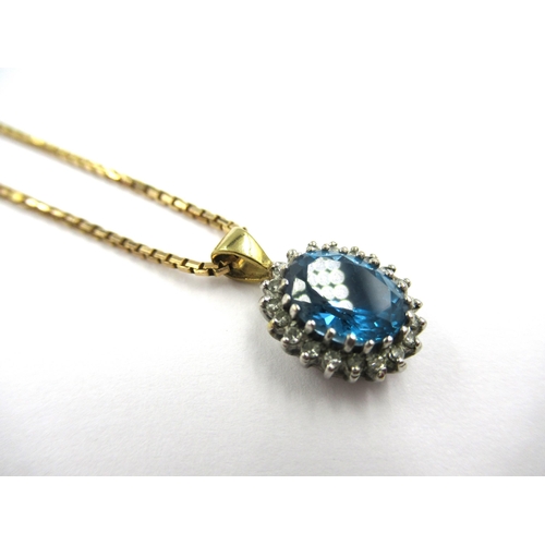 707 - Oval blue zircon and diamond cluster pendant suspended from a 9ct gold chain