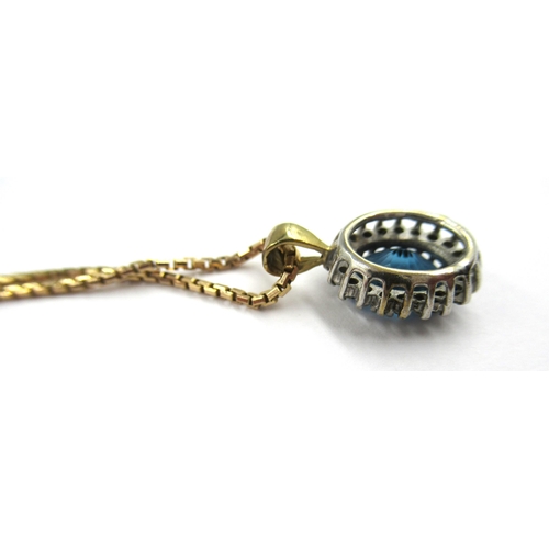 707 - Oval blue zircon and diamond cluster pendant suspended from a 9ct gold chain