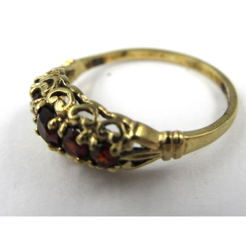 725 - 9ct Yellow gold five stone garnet set ring, size K