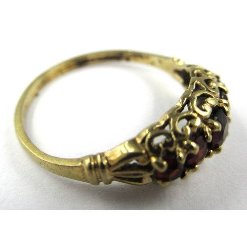 725 - 9ct Yellow gold five stone garnet set ring, size K