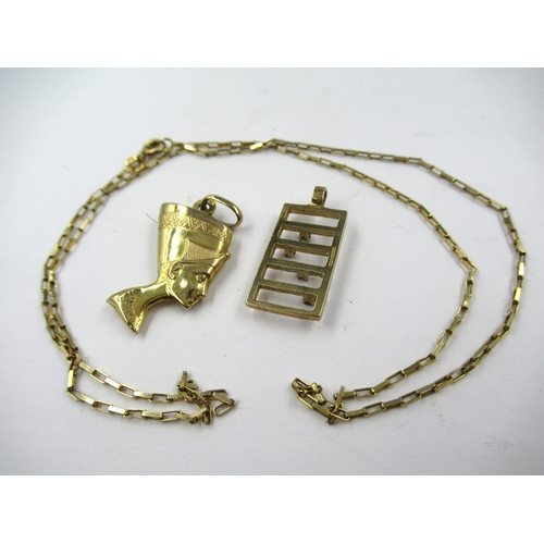 763 - 9ct Gold charm in the form of Nefertiti, 9ct gold chain and a 9ct gold pendant set various gemstones... 