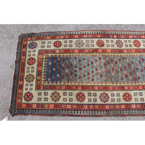 8 - Antique Kazak runner, with all-over stylised floral design on blue ground, with rosette borders, 230... 