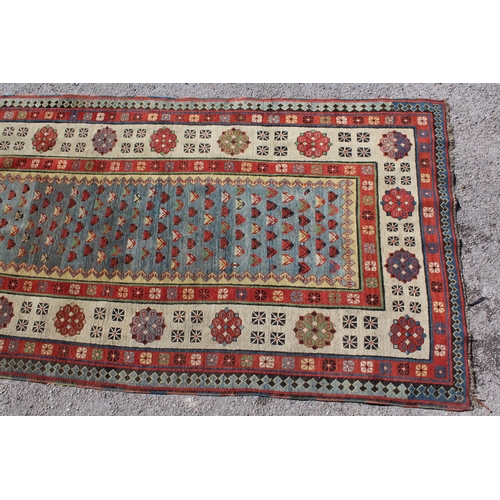 8 - Antique Kazak runner, with all-over stylised floral design on blue ground, with rosette borders, 230... 