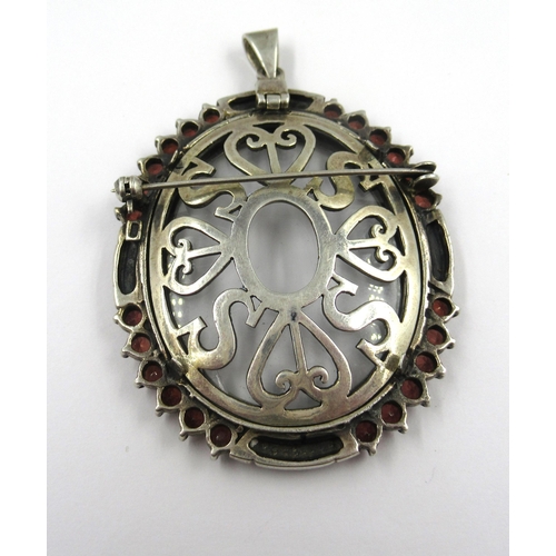 828 - Silver garnet and marcasite mounted oval portrait pendant