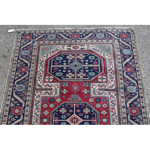 9 - Anatolian rug with triple medallion design in shades of blue, claret and ivory, 177cms x 120cms