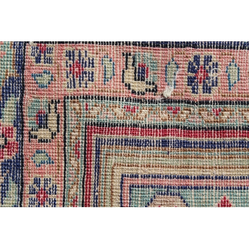 9 - Anatolian rug with triple medallion design in shades of blue, claret and ivory, 177cms x 120cms
