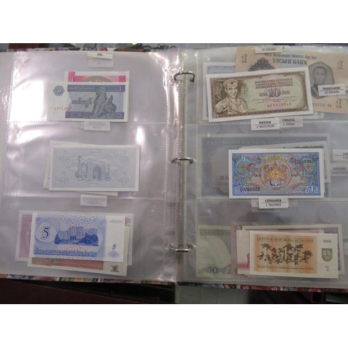 807 - Two folders containing a quantity of World bank notes