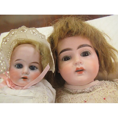 195 - Early 20th Century German bisque headed doll with sleeping eyes, open mouth and four teeth on a join... 
