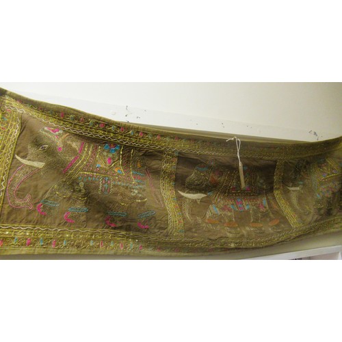 100 - Framed Indian silkwork and textile picture, 80cms x 40cms, together with an unframed panel depicting... 