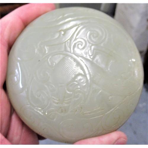 152 - Small 20th Century carved pale green jade circular box and cover, decorated in shallow relief, 8.5cm... 