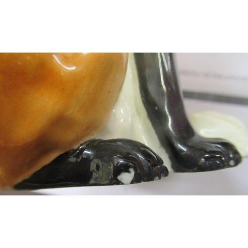 419 - Royal Worcester porcelain figure of a seated fox, No. 2993 (small chip to one foot) 19cms high