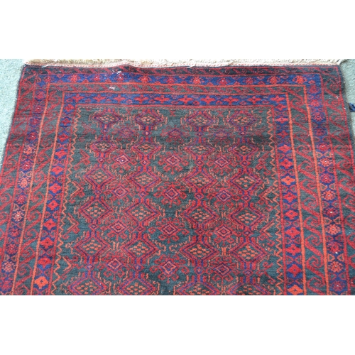 10 - Belouch rug with an all-over stylised design on a dark ground with multiple border, 173cms x 103cms