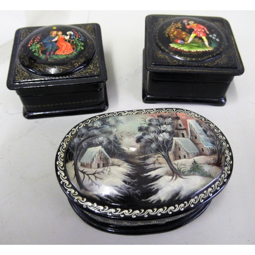 129 - Two modern Russian papier mache boxes having hinged covers decorated with figures, signed, together ... 