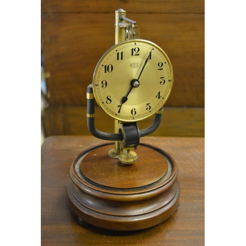 Bulle electric mantel clock on a circular mahogany base with glass