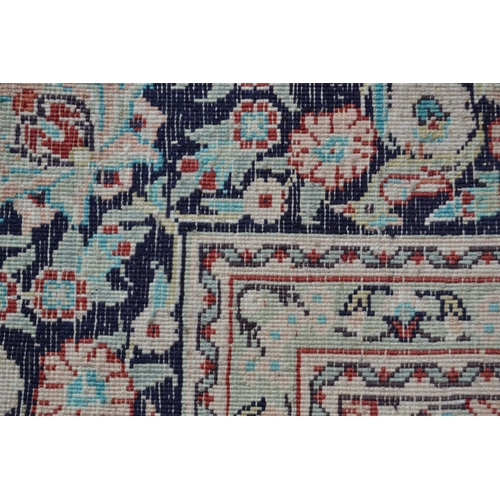 16 - Modern Qum style rug with a medallion and all-over floral and vase design on ivory ground with borde... 