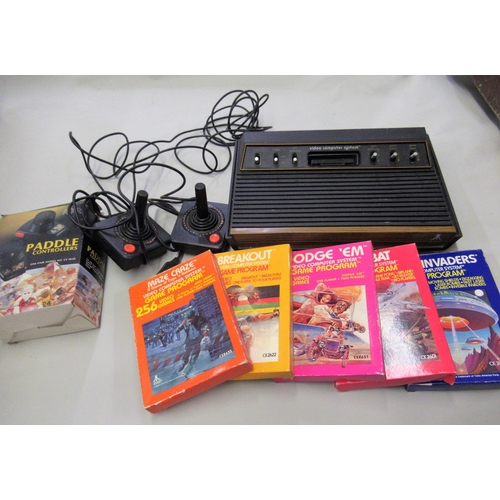 171 - Box containing an Atari games console with controllers, five games, instruction manual and later Ata... 