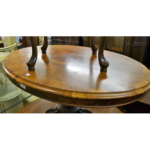 1796 - Small 19th Century oval figured walnut tilt-top centre table, on carved column and four splay suppor... 