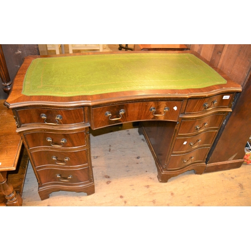 1836 - Reproduction mahogany serpentine shaped twin pedestal desk, with a green tooled leather inset top ab... 