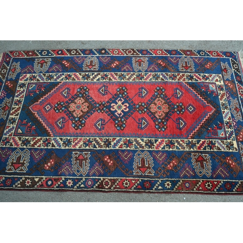 19 - Modern Turkish rug with a triple medallion design in shades of red and blue, 204cms x 121cms