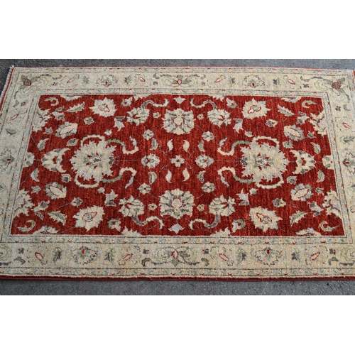 21 - Small Indo Persian rug of Ziegler design, with a red ground and ivory borders, 160cms x 96cms