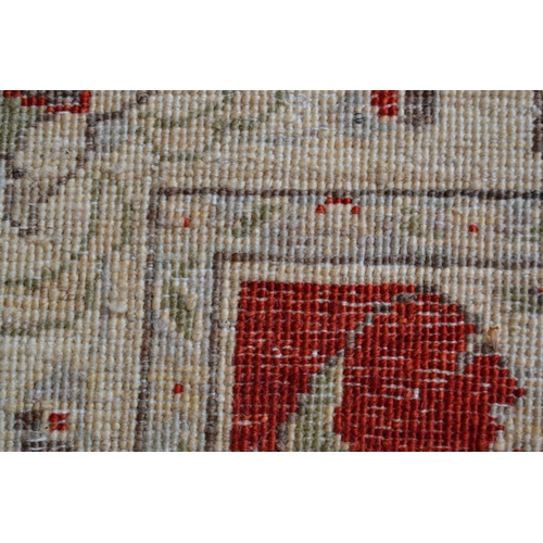 21 - Small Indo Persian rug of Ziegler design, with a red ground and ivory borders, 160cms x 96cms
