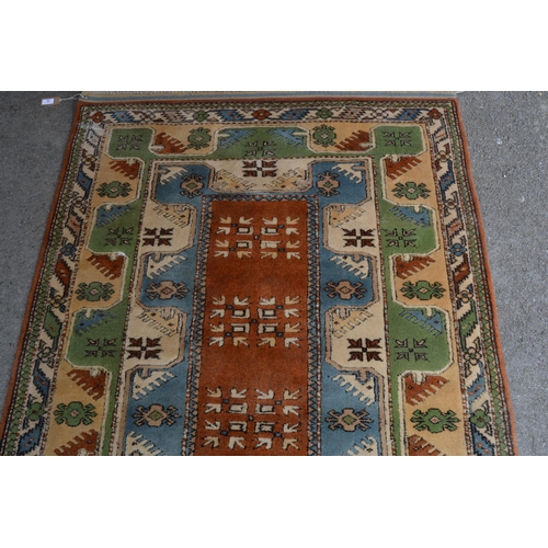 24 - Modern Milas (Turkey) rug with a rectangular centre medallion and double border, in shades of rust, ... 