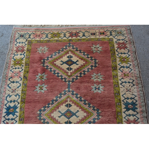 25 - Modern Turkish rug with a triple medallion design on a rose ground with borders, 180cms x 120cms