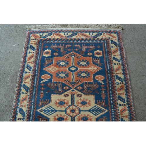 26 - Modern Turkish rug of Caucasian design with a triple medallion on a blue ground with borders, 180cms... 