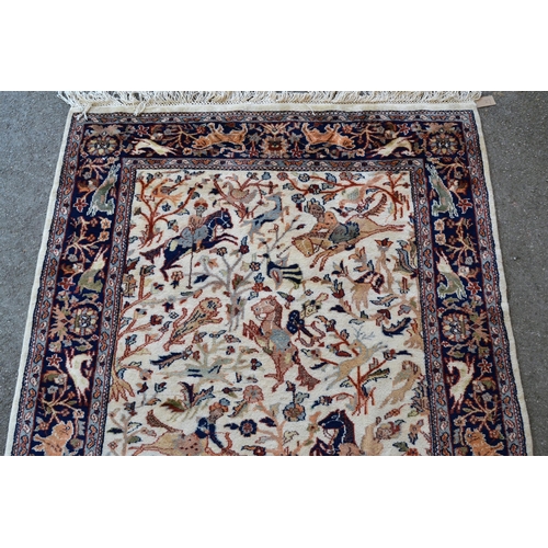 27 - Modern Indo Persian rug with an all-over hunting design on an ivory ground with borders, 180cms x 12... 