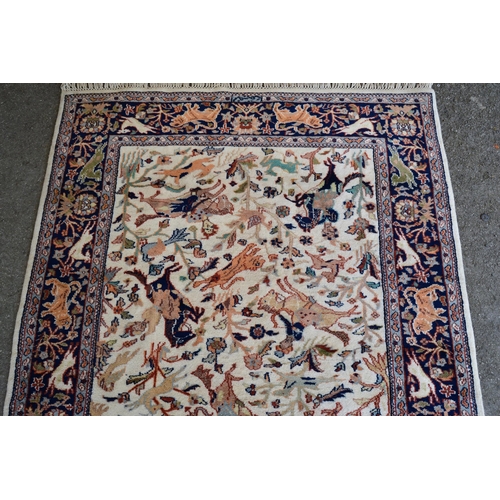27 - Modern Indo Persian rug with an all-over hunting design on an ivory ground with borders, 180cms x 12... 