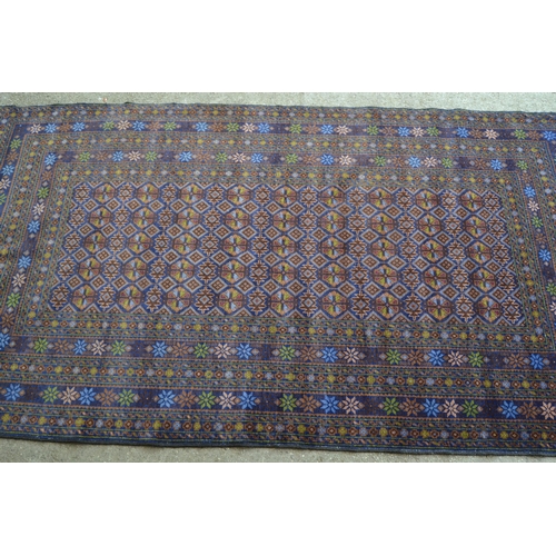 28 - Modern Belouch rug with an all-over stylised flower head design in rectangular centre panel, with mu... 