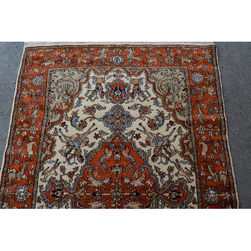 38 - Indo Persian rug with a medallion and hunting design in shades of iron red and cream, 183cms x 122cm... 