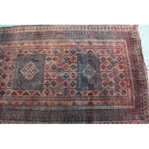 5 - Afghan Belouch rug with a triple medallion and all-over stylised design on a rust ground with multip... 
