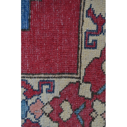 7 - Turkish rug of Caucasian design with triple medallion on a rose ground with borders, 184cms x 145cms