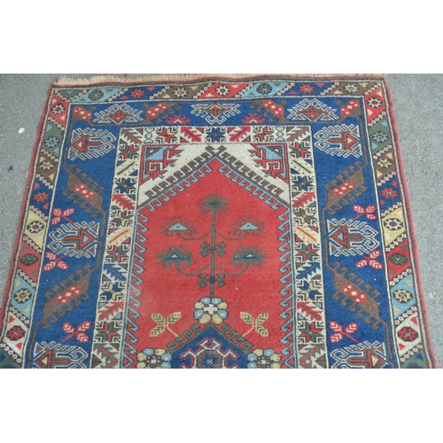9 - Modern Turkish rug with a medallion and floral design centre panel, blue ground borders and twin sub... 