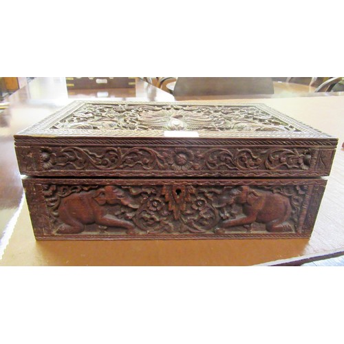 194 - Indian carved wooden rectangular workbox, together with a silver backed mirror