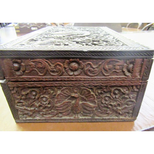 194 - Indian carved wooden rectangular workbox, together with a silver backed mirror