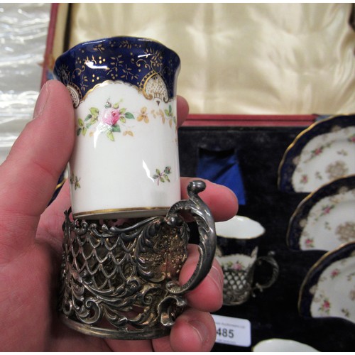 485 - Cased set of six Coalport porcelain coffee cans and saucers with silver holders